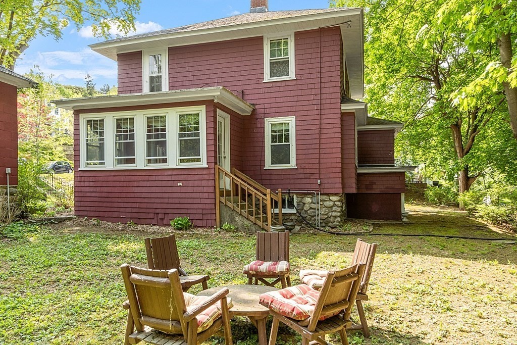 24 Maplewood Road Worcester, MA 01602 - Photo 34 of 42 a view of a brick house with a chairs in patio