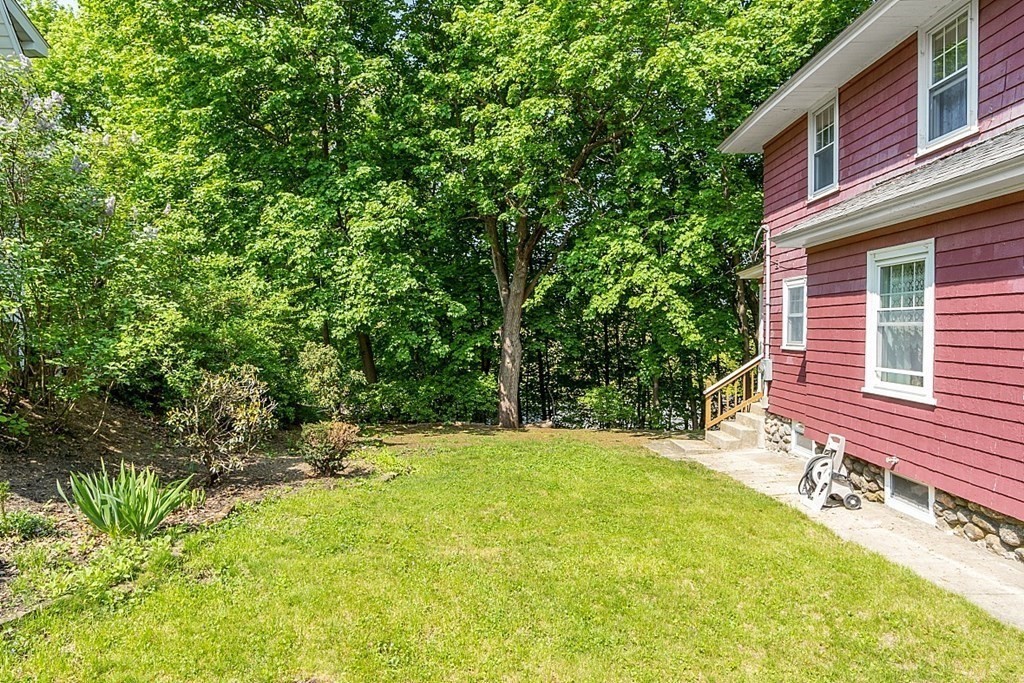 24 Maplewood Road Worcester, MA 01602 - Photo 37 of 42 a backyard of a house with table and chairs