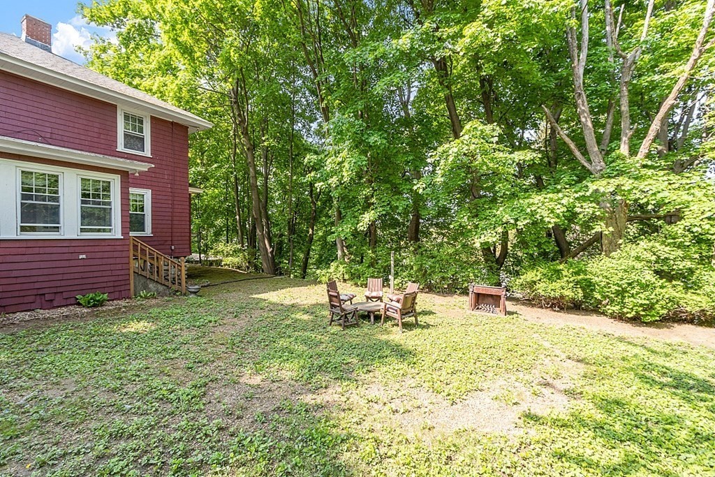 24 Maplewood Road Worcester, MA 01602 - Photo 4 of 42 a backyard of a house with yard and outdoor seating