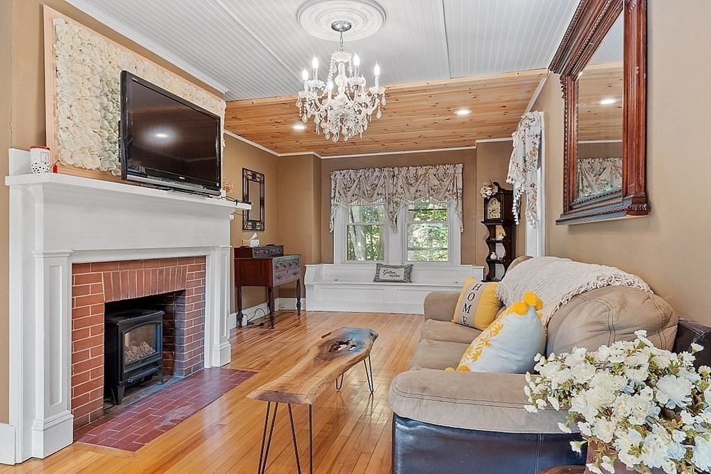 24 Maplewood Road Worcester, MA 01602 - Photo 5 of 42 a living room with furniture a flat screen tv and a fireplace