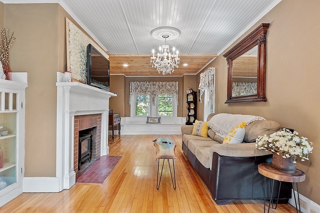 24 Maplewood Road Worcester, MA 01602 - Photo 6 of 42 a living room with furniture fireplace and a large window