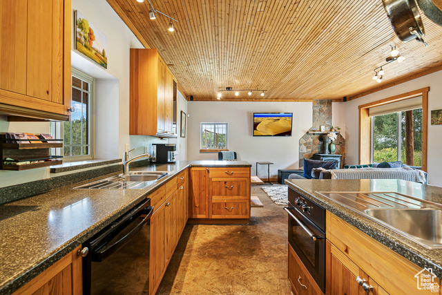 2029 West Tollgate Road Coalville, UT 84017 - Photo 11 of 43 Kitchen with rail lighting, brown cabinets, a peninsula, healthy amount of natural light, and wooden ceiling