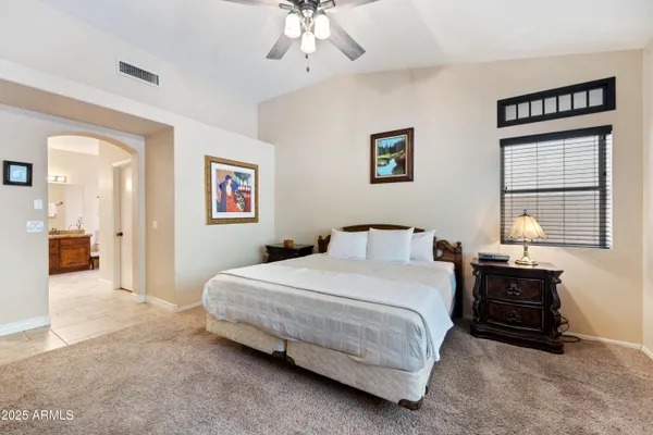 a bedroom with a bed and a large window