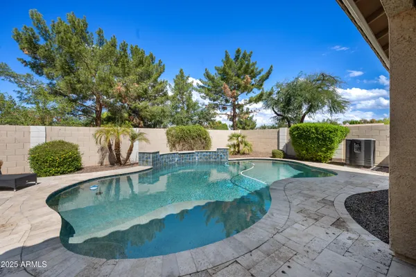 a view of a backyard with large trees