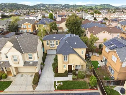 an aerial view of residential houses with outdoor space and parking