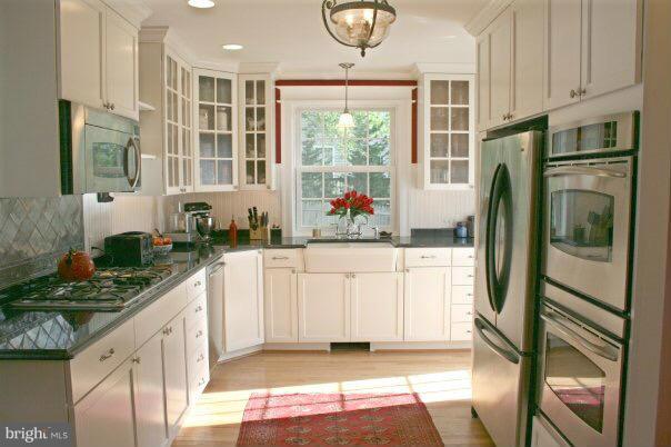 1953 Seminary Road Silver Spring, MD 20910 - Photo 17 of 23 a kitchen with stainless steel appliances granite countertop a refrigerator and a stove
