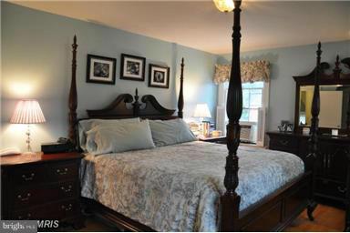 1953 Seminary Road Silver Spring, MD 20910 - Photo 21 of 23 a bed room with a bed and a lamp
