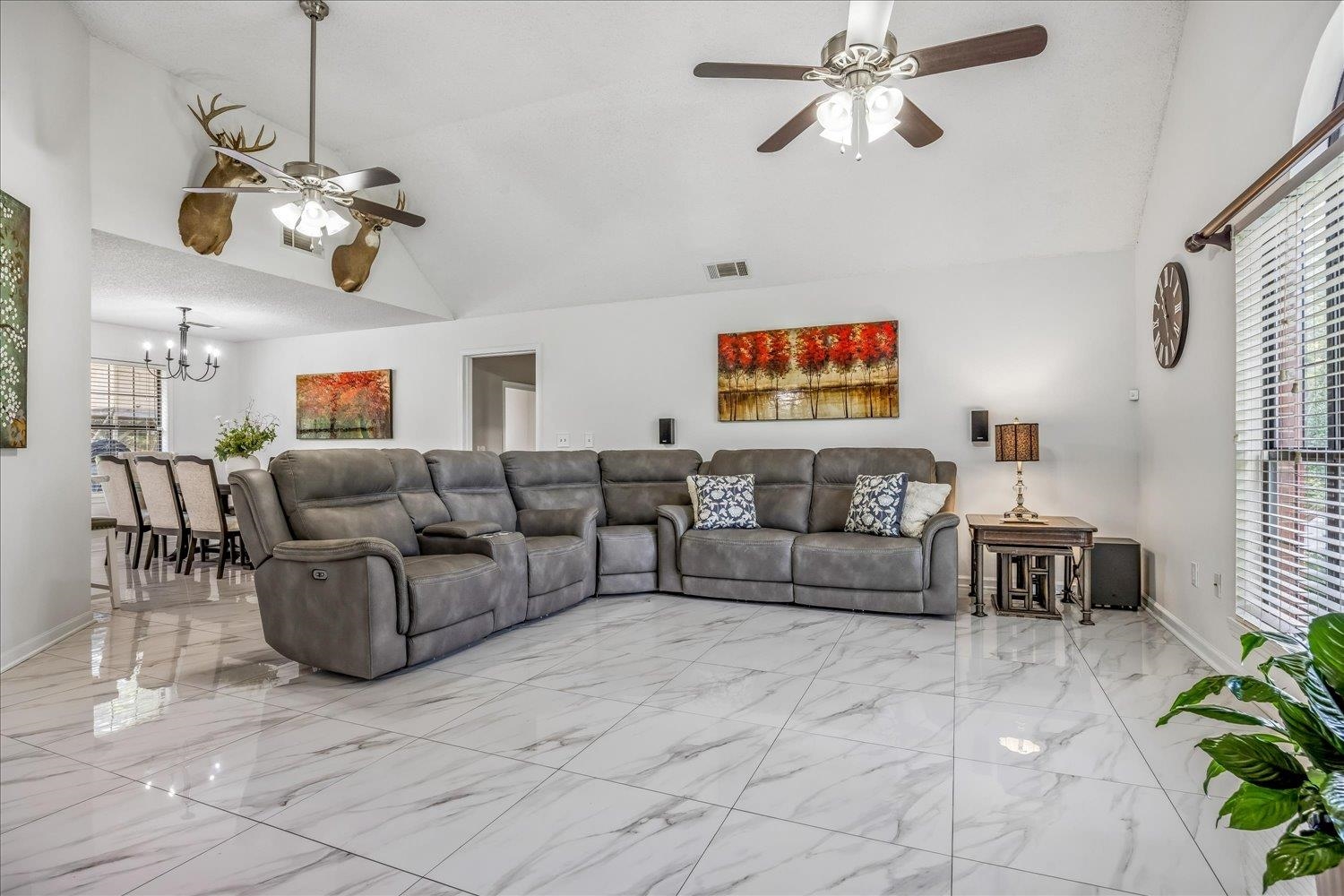 184 Cherokee Road Millington, TN 38053 - Photo 3 of 27 Spacious interior featuring high vaulted ceilings, large format tile flooring, and a dining area visible beyond