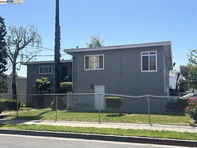 5775 Walnut Street Oakland, CA 94605 - Photo 2 of 3 a view of a house with a big yard and potted plants