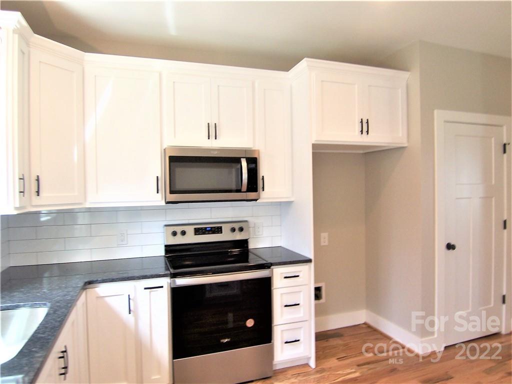 2933 Philadelphia Road Lawndale, NC 28090 - Photo 16 of 43 a kitchen with stainless steel appliances a stove microwave and sink
