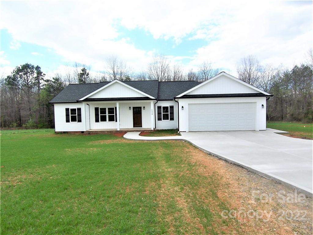 2933 Philadelphia Road Lawndale, NC 28090 - Photo 3 of 43 a front view of a house with a garden