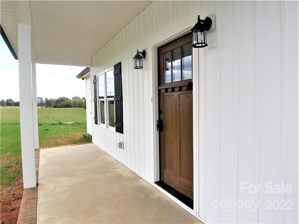 2933 Philadelphia Road Lawndale, NC 28090 - Photo 6 of 43 a view of a porch with a floor to ceiling window and garden