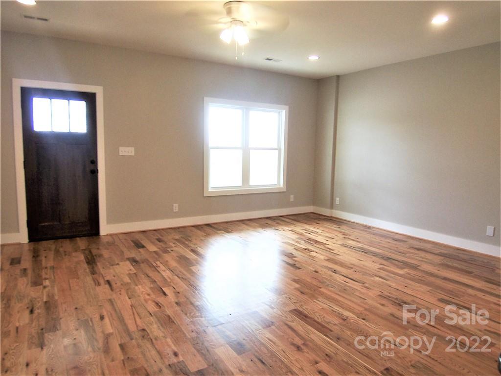 2933 Philadelphia Road Lawndale, NC 28090 - Photo 8 of 43 an empty room with wooden floor and windows