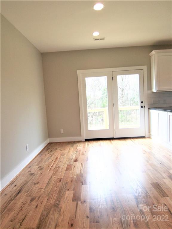 2933 Philadelphia Road Lawndale, NC 28090 - Photo 10 of 43 an empty room with wooden floor and windows