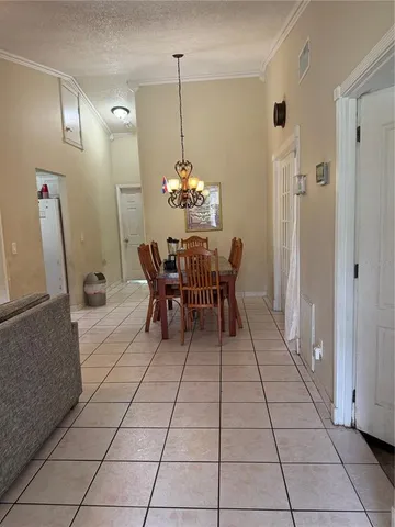 a view of a dining room with furniture and chandelier