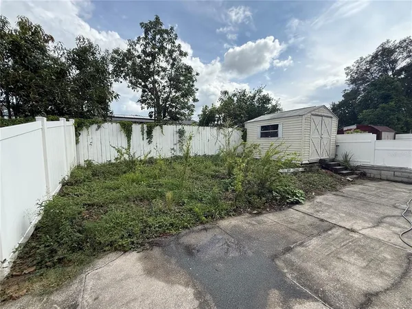 a backyard of a house with plants and trees