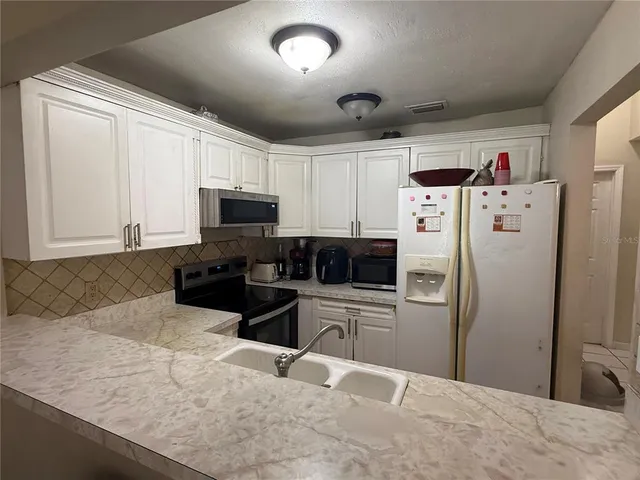 a kitchen with a refrigerator sink and microwave