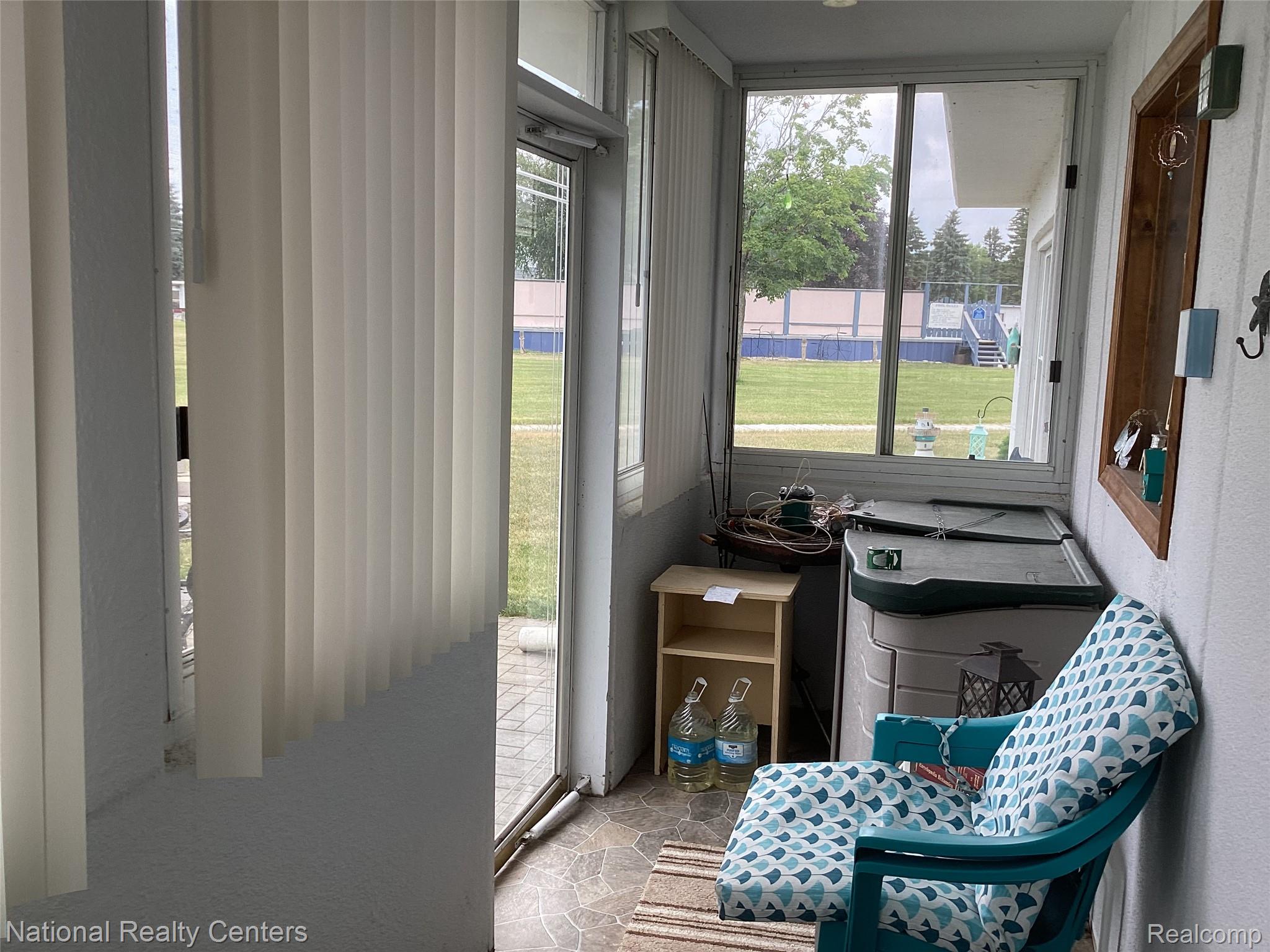6024 Port Austin Road, Unit 5 Caseville, MI 48725 - Photo 45 of 56 Front door of extra sunroom space with more storage