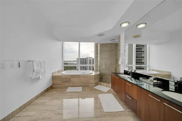 a large white kitchen with a large window