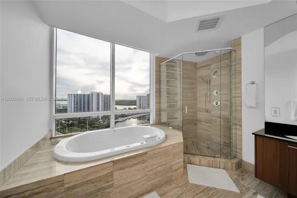 a bathroom with a sink a bathtub and a shower