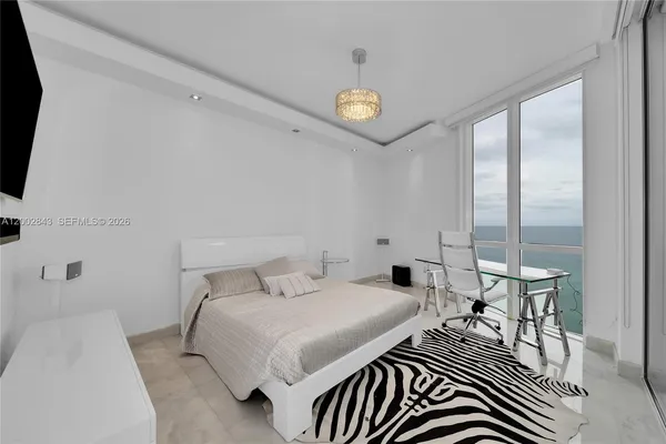 a bedroom with a bed and a table in it