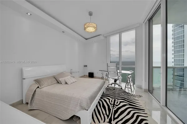 a bedroom with a bed and a table in it