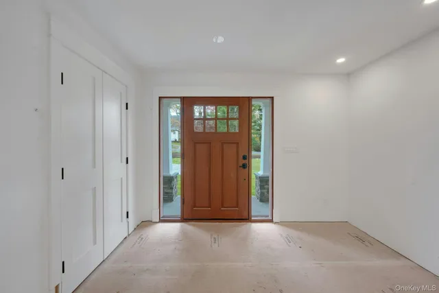 a large kitchen with stainless steel appliances kitchen island a large counter top and a stove top oven