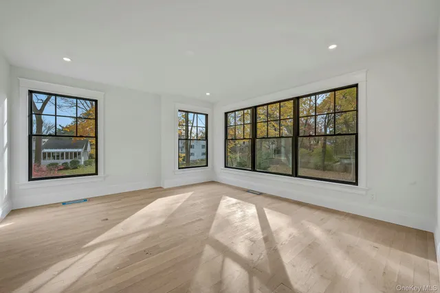 a view of an empty room with a window and brick wall