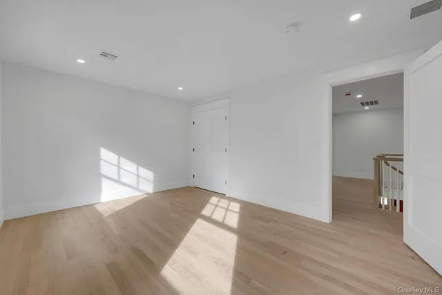 a bedroom with a bed a table and painting