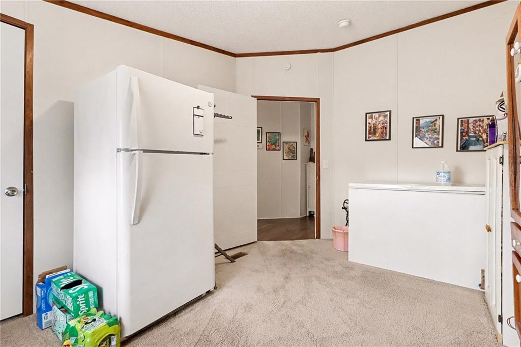 99 James Drive Hampton, GA 30228 - Photo 12 of 25 a white refrigerator freezer sitting in a kitchen