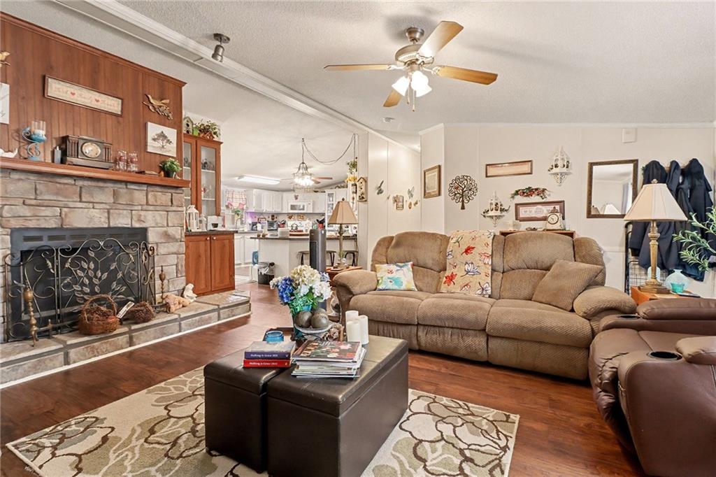 99 James Drive Hampton, GA 30228 - Photo 4 of 25 a living room with furniture a fireplace and a table