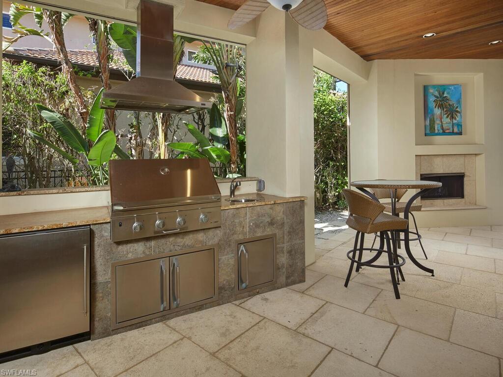 377 Pirates Bight Naples, FL 34103 - Photo 17 of 44 a kitchen with a sink and a stove top oven