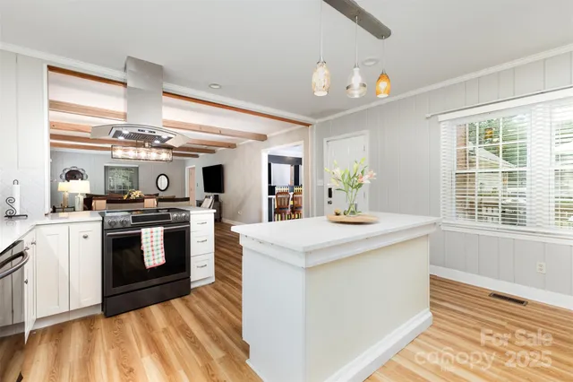 a kitchen with a stove a sink and a refrigerator