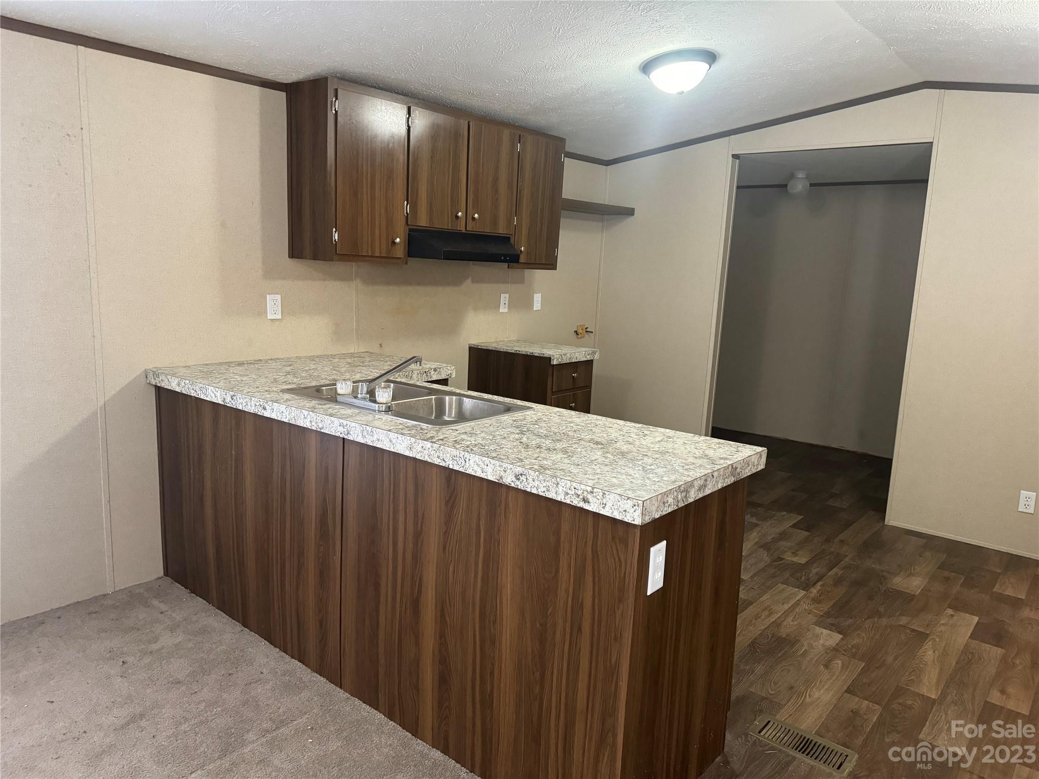 117 Railroad Street Rockingham, NC 28379 - Photo 5 of 14 a kitchen with a sink a microwave and cabinets