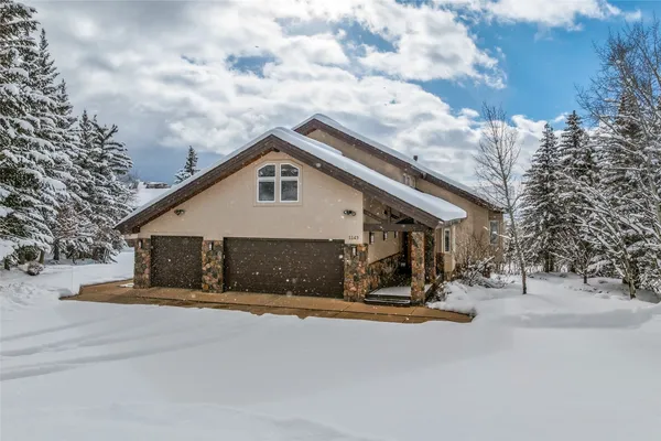 a view of a house with snow on the road