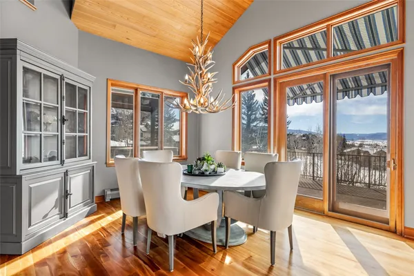 a view of a dining room with furniture large windows and wooden floor