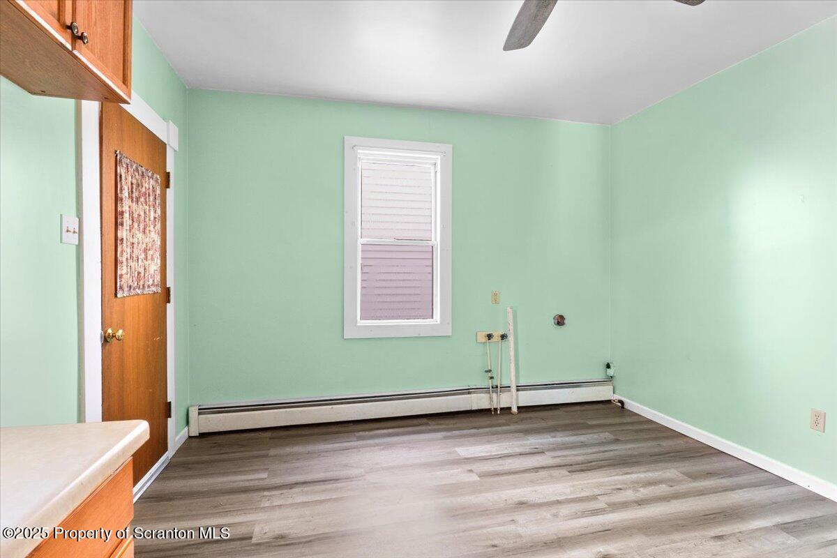 76 Mary Street Ashley, PA 18706 - Photo 11 of 30 an empty room with wooden floor and windows