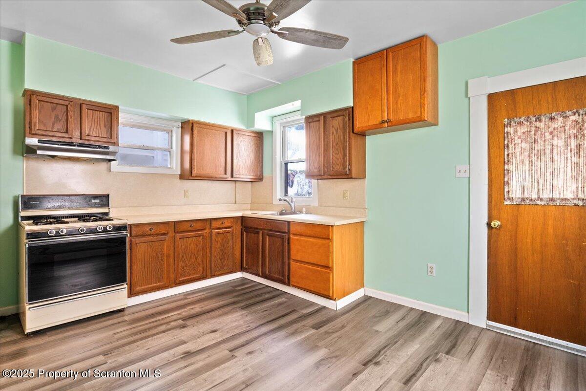 76 Mary Street Ashley, PA 18706 - Photo 13 of 30 a kitchen with stainless steel appliances granite countertop a stove a sink and a microwave