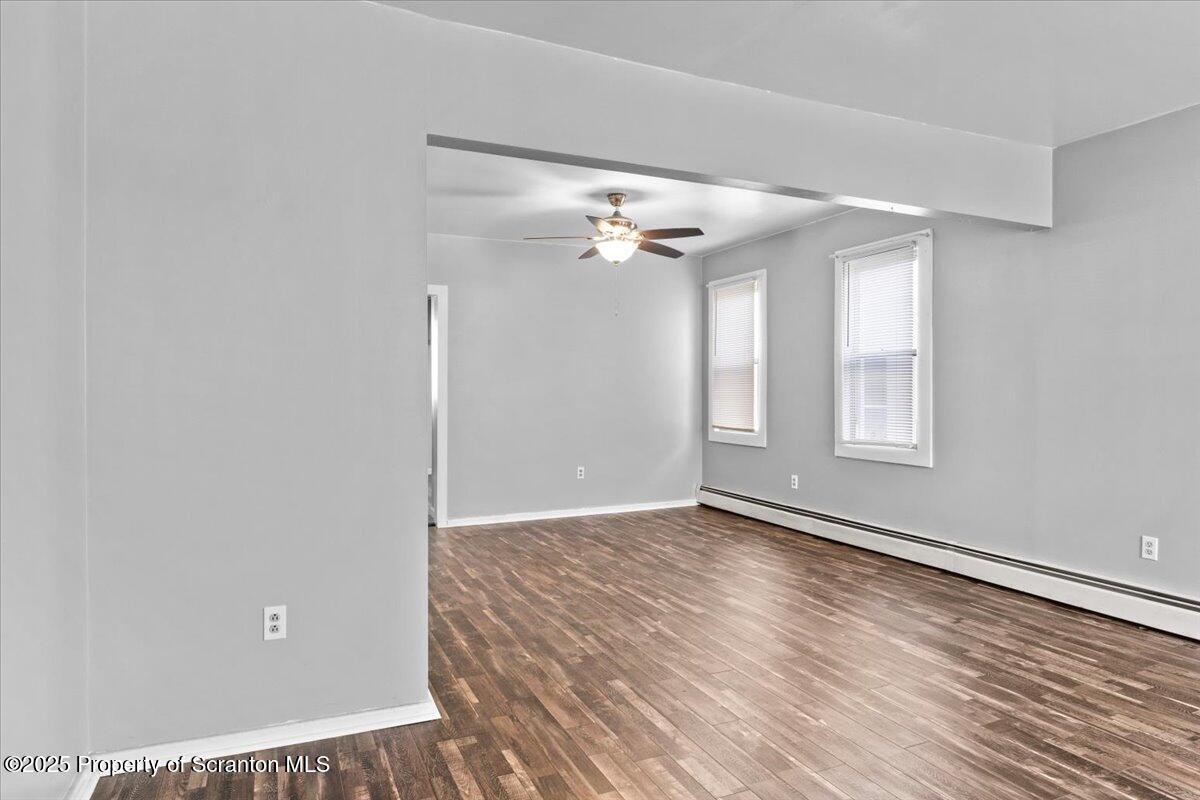 76 Mary Street Ashley, PA 18706 - Photo 7 of 30 wooden floor in an empty room with a window