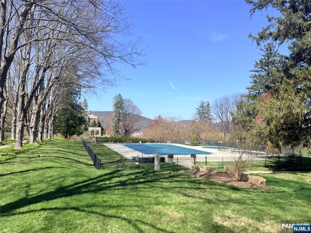 3104 Rio Vista Drive, Unit 3104 Mahwah, NJ 07430 - Photo 24 of 32 a view of a lake with a yard and large trees