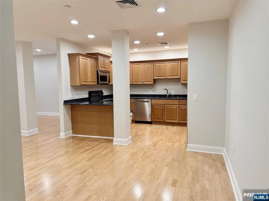 3104 Rio Vista Drive, Unit 3104 Mahwah, NJ 07430 - Photo 4 of 32 a kitchen with stainless steel appliances granite countertop a sink and cabinets
