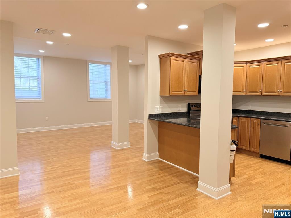 3104 Rio Vista Drive, Unit 3104 Mahwah, NJ 07430 - Photo 5 of 32 a kitchen with granite countertop a sink and cabinets