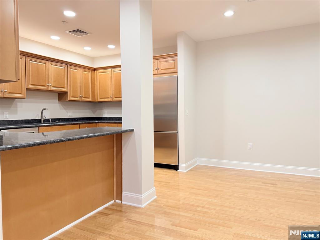 3104 Rio Vista Drive, Unit 3104 Mahwah, NJ 07430 - Photo 8 of 32 a kitchen with stainless steel appliances granite countertop a refrigerator and a sink