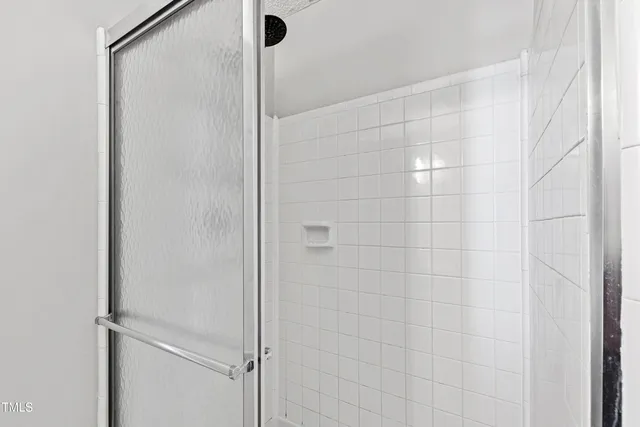 a bathroom with a glass shower door