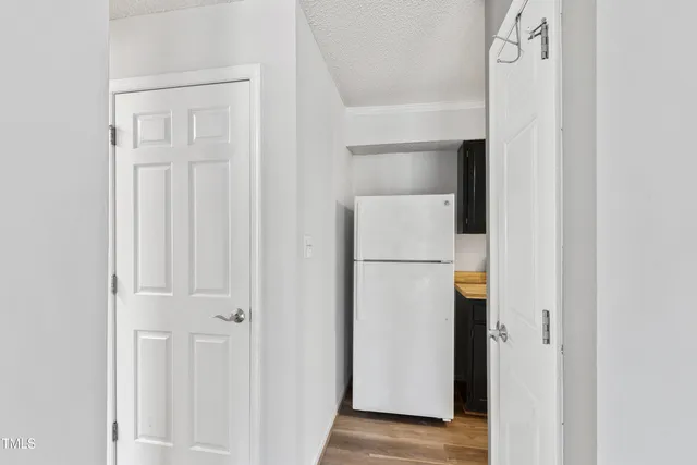 a view of hallway with cabinets