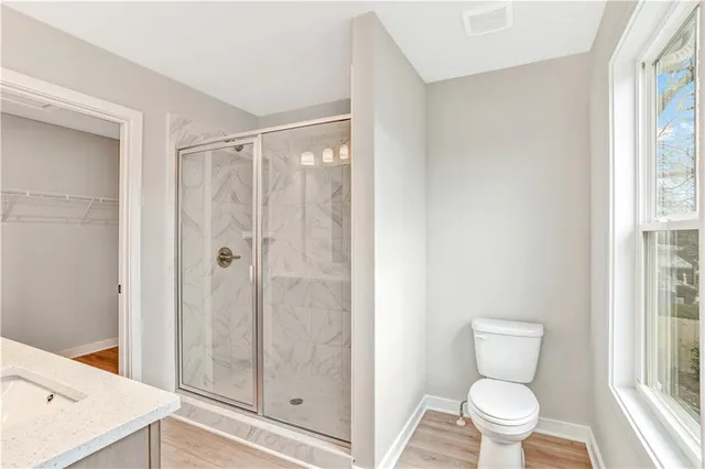 a bathroom with a toilet and a shower