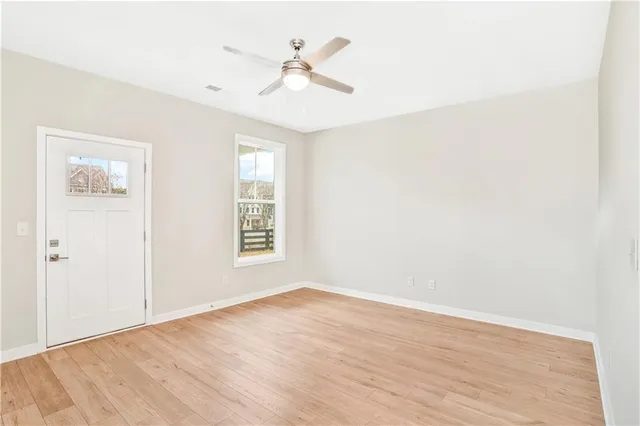 wooden floor in an empty room with a window
