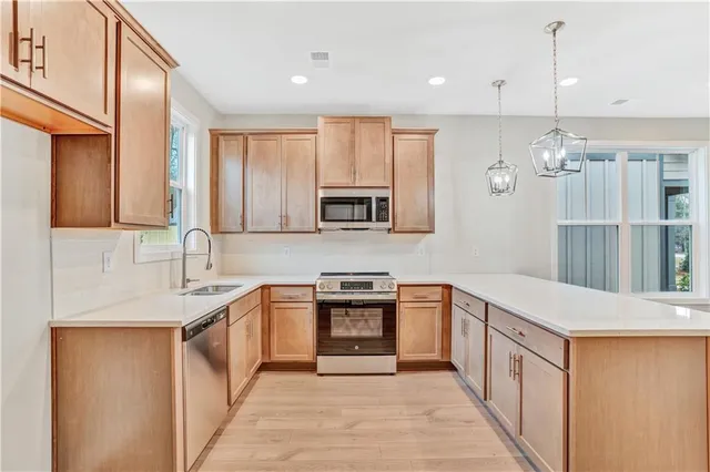 a kitchen with a sink stove and microwave