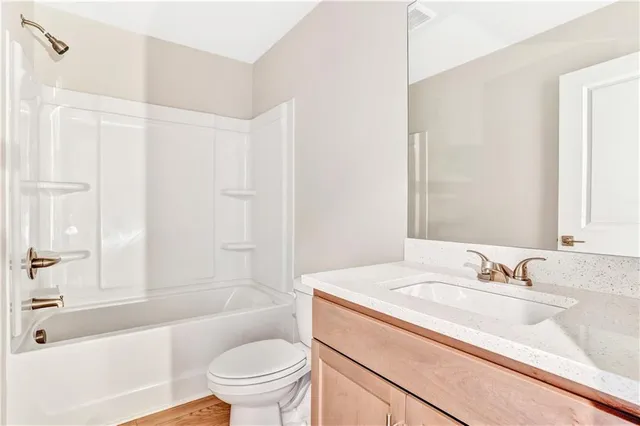 a bathroom with a sink a toilet and a bathtub