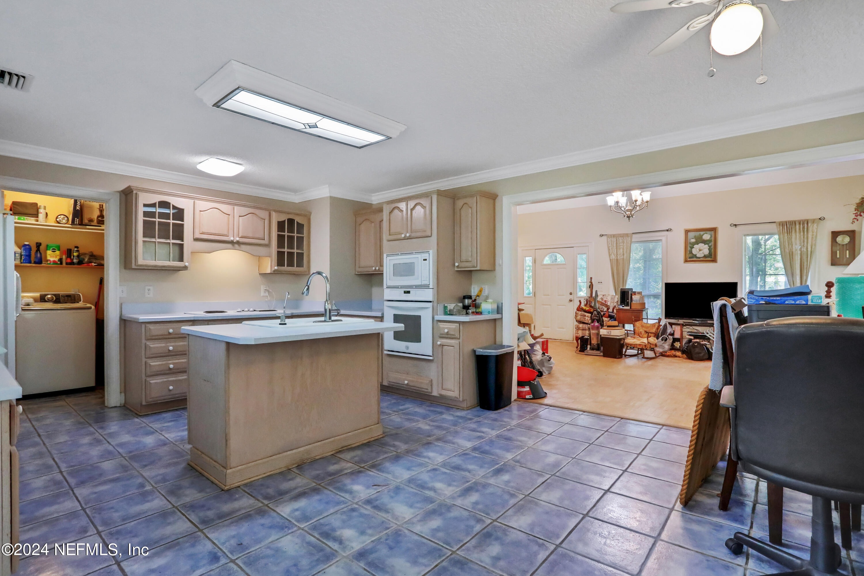 5321 Sweat Road Green Cove Springs, FL 32043 - Photo 13 of 31 a kitchen with stainless steel appliances granite countertop a sink counter space and living room view
